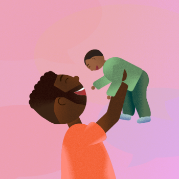 Father holding child in the air and smiling